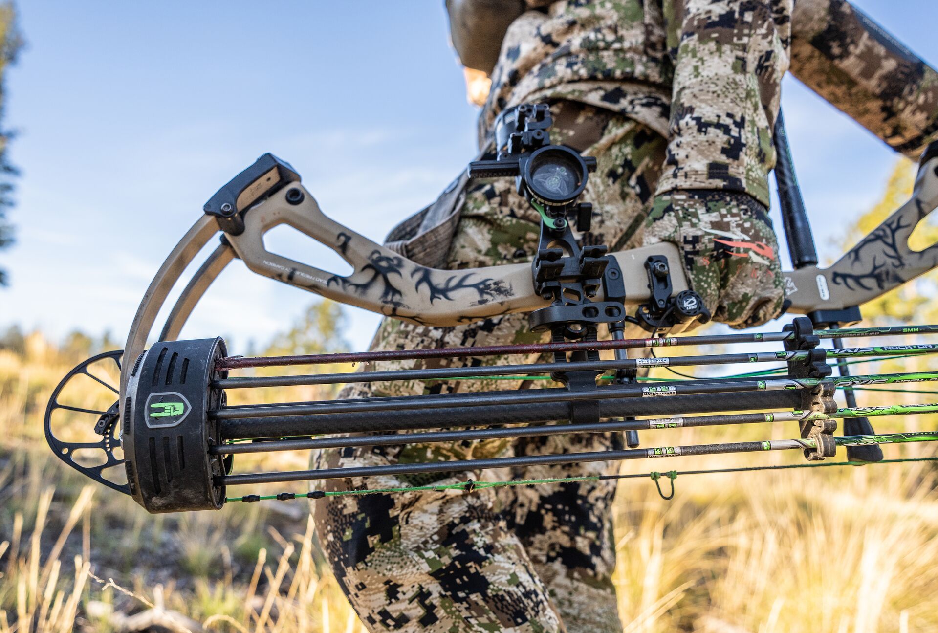 Close-up of a compound bow held at a hunter's side, know the parts of a bow concept. 