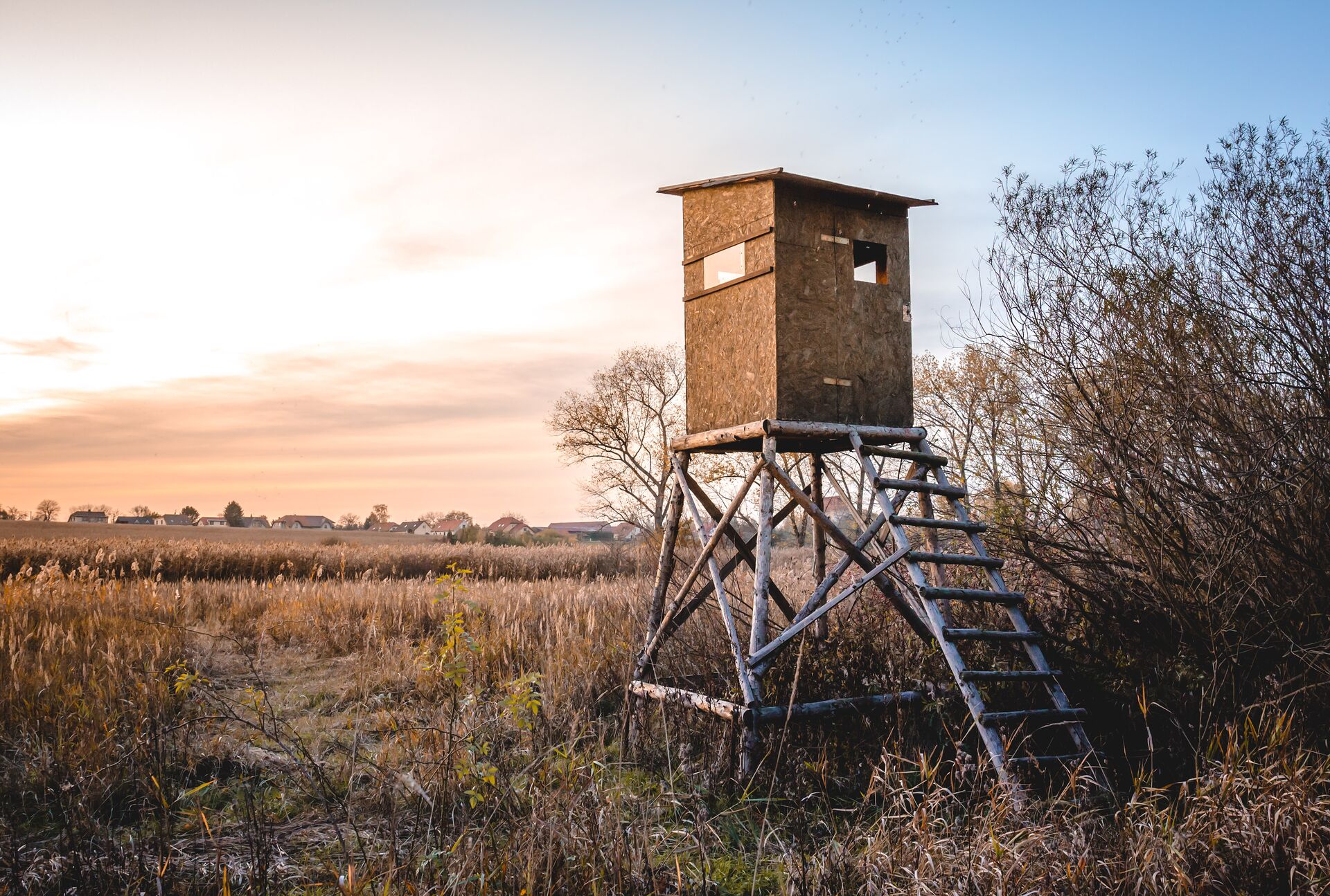 An elevated hunting blind in a field, what does open season hunting mean concept. 