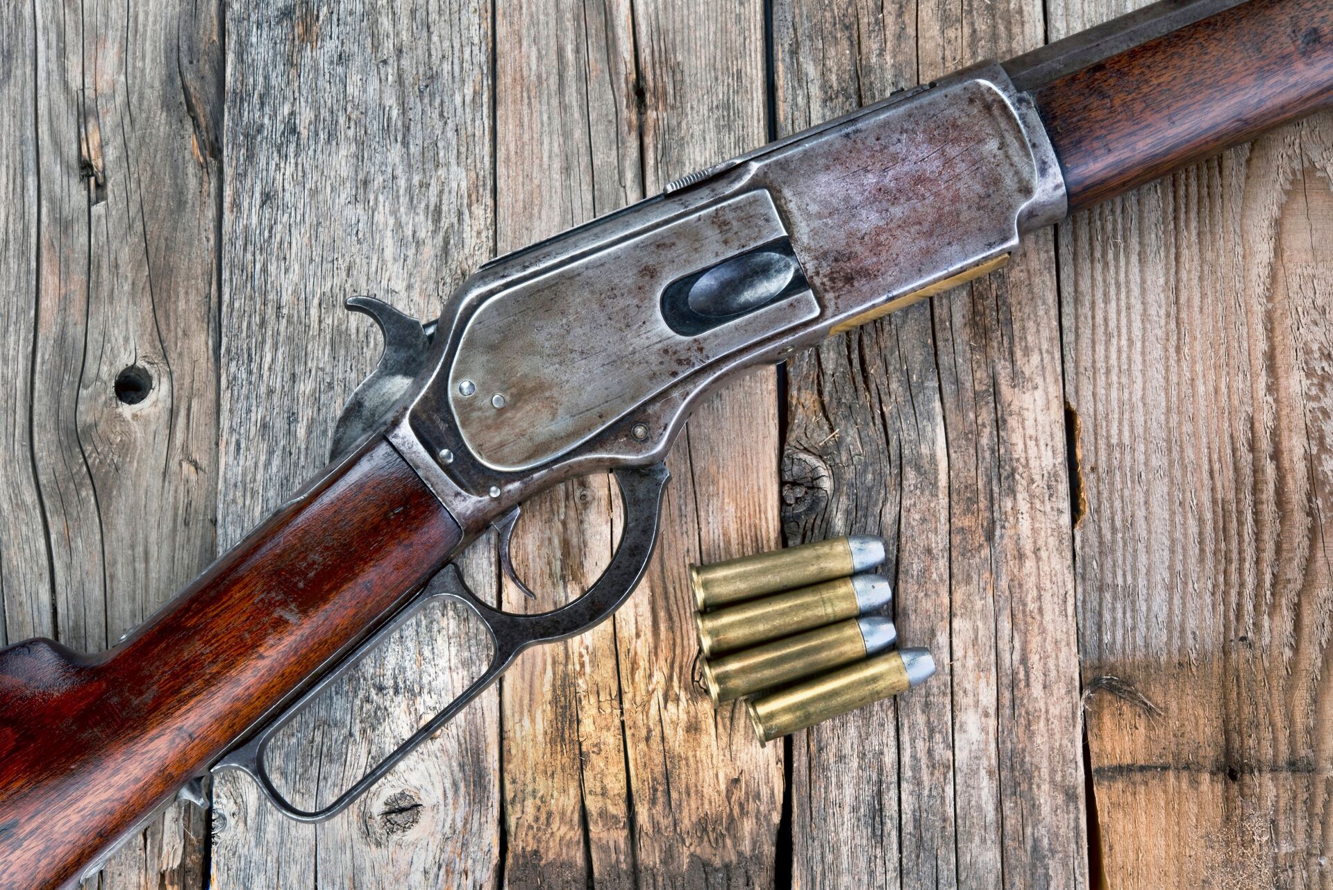 A rifle lays on a table next to ammunition, causes of a hang fire concept. 