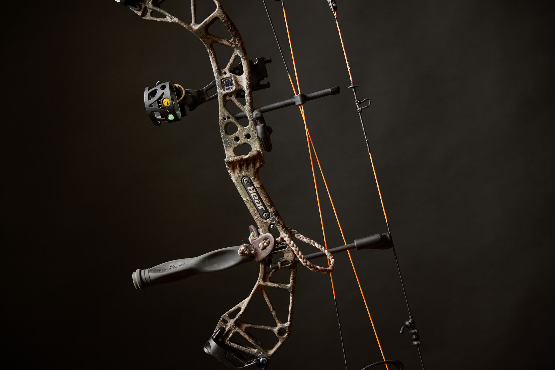 A compound bow on a dark background, learning to be a better bowhunter concept. 