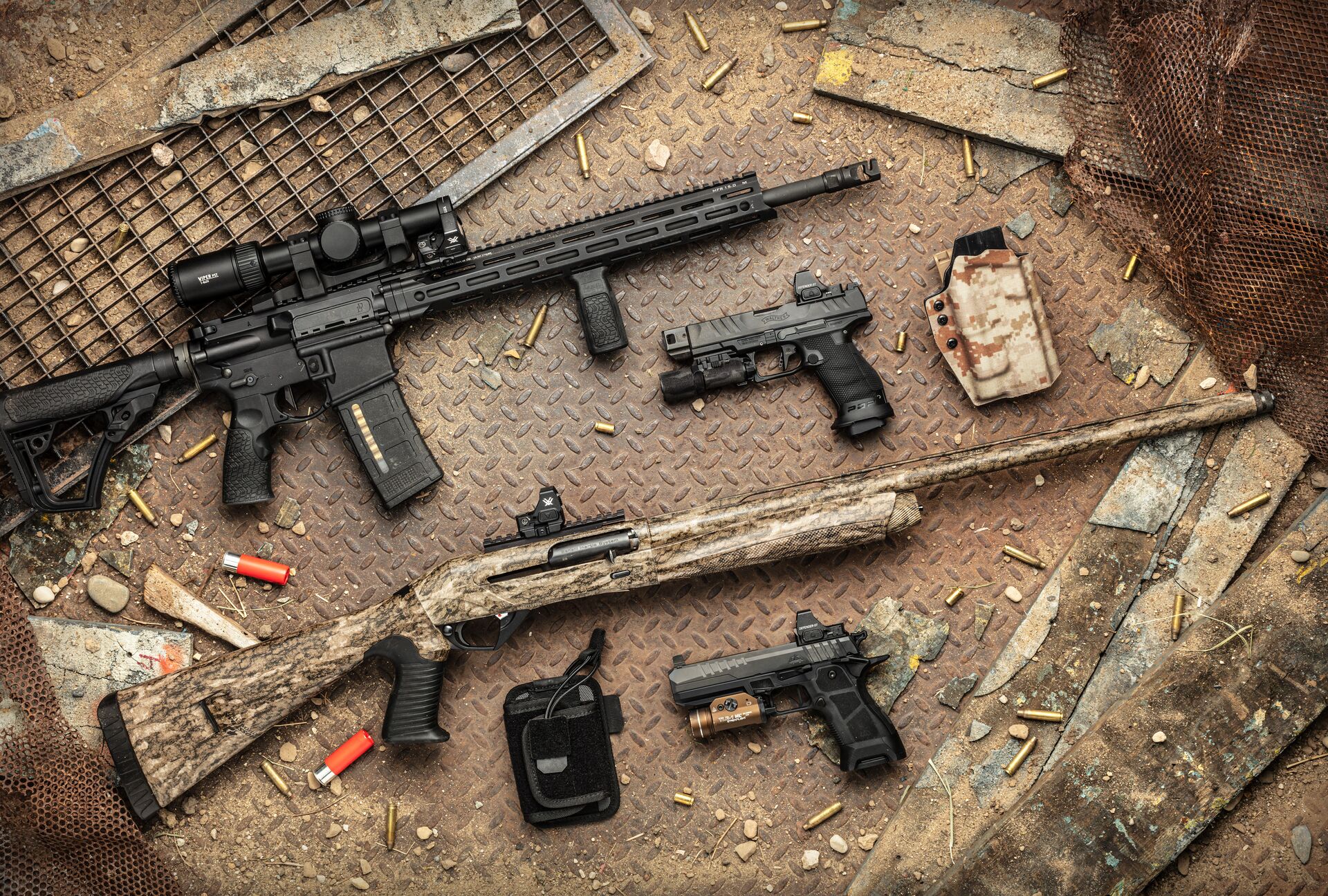 Different types of firearms on a table. 