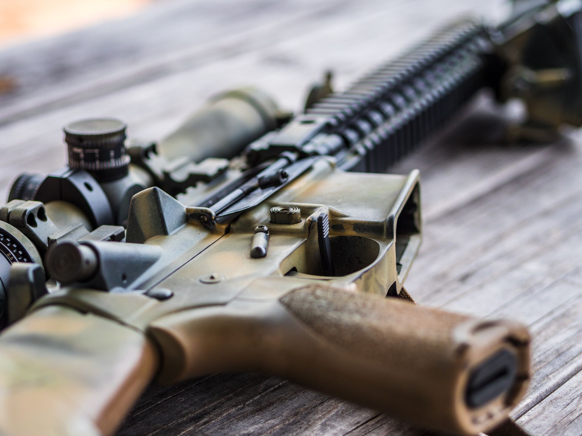 Close-up of a semiautomatic rifle on a table.